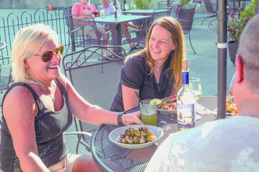 People Enjoying wine at a table outside